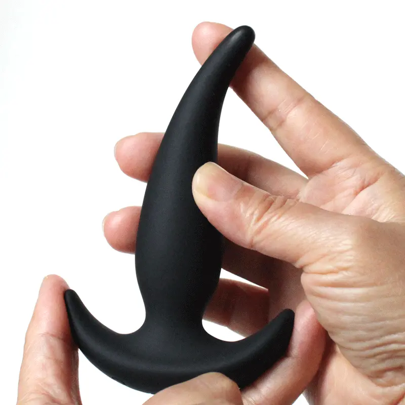 Boom beginner anal plug shown in hand, highlighting its soft, flexible silicone material for comfort and easy insertion.