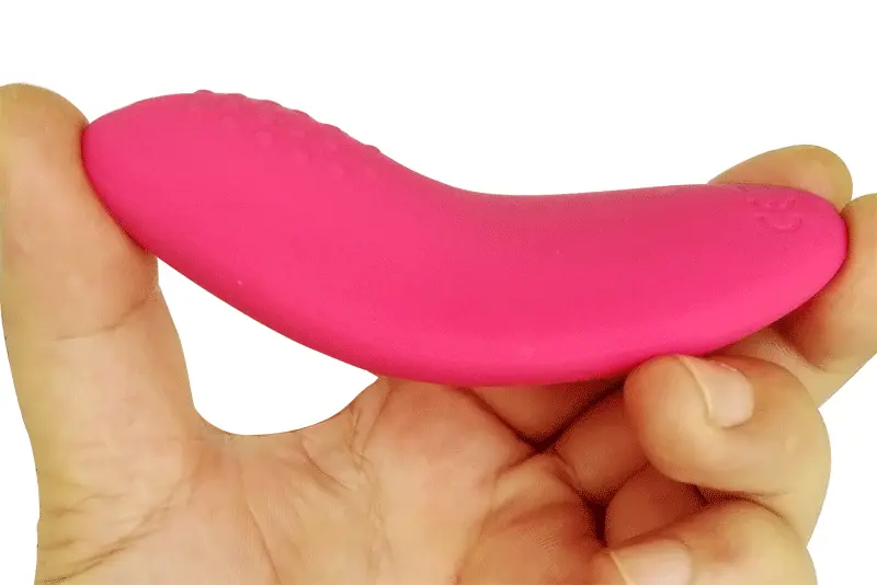Kite panty vibrator shown being flexed with two fingers to demonstrate its softness and flexibility, emphasizing the comfort and adaptability for intimate wear.