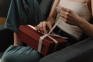 A man surprising his wife with a new vibrator as an intimate gift.
