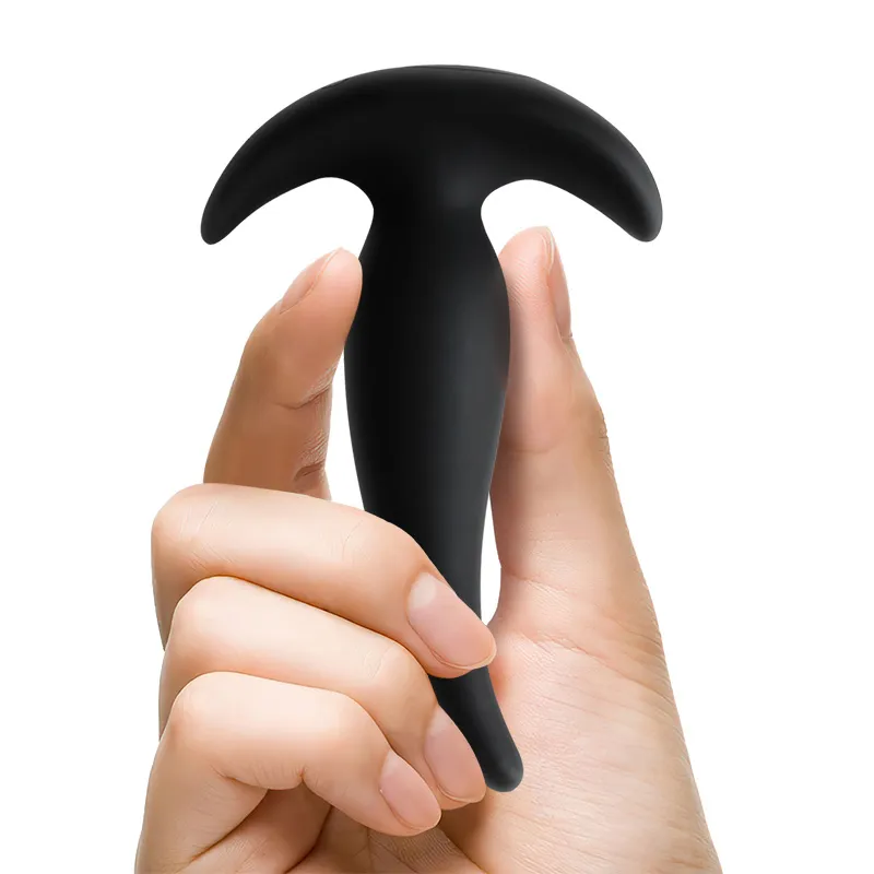 Boom beginner anal plug held in hand, showcasing its compact and portable size, designed for easy handling and discreet storage.