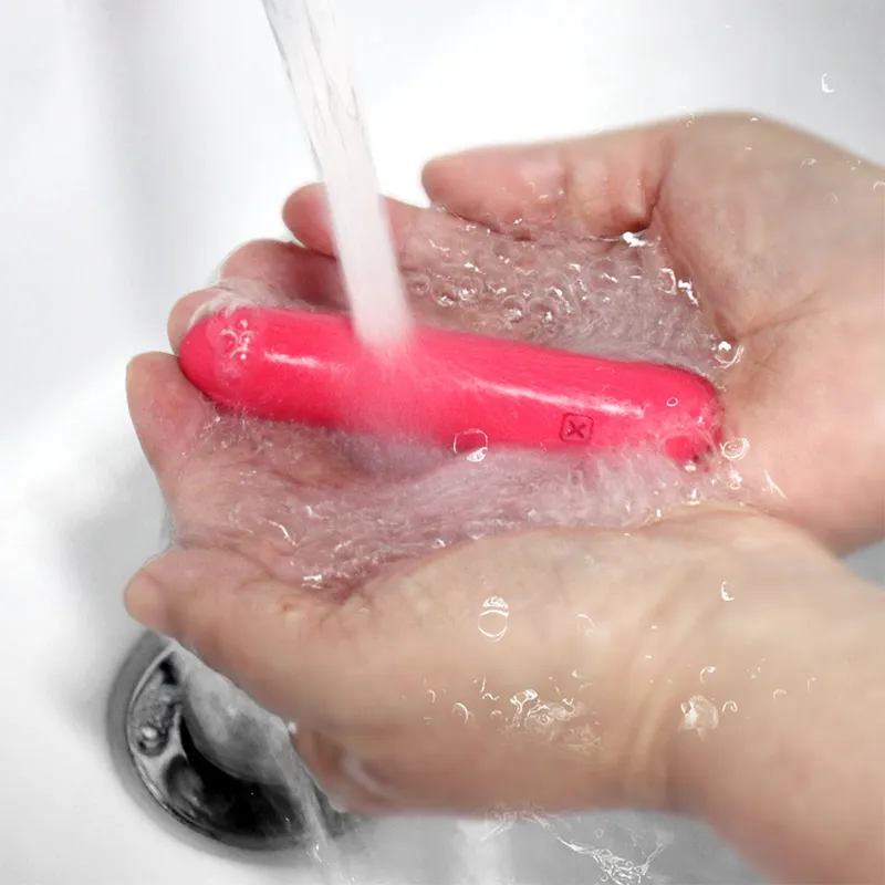 Mash bullet vibrator being rinsed under faucet for easy cleaning